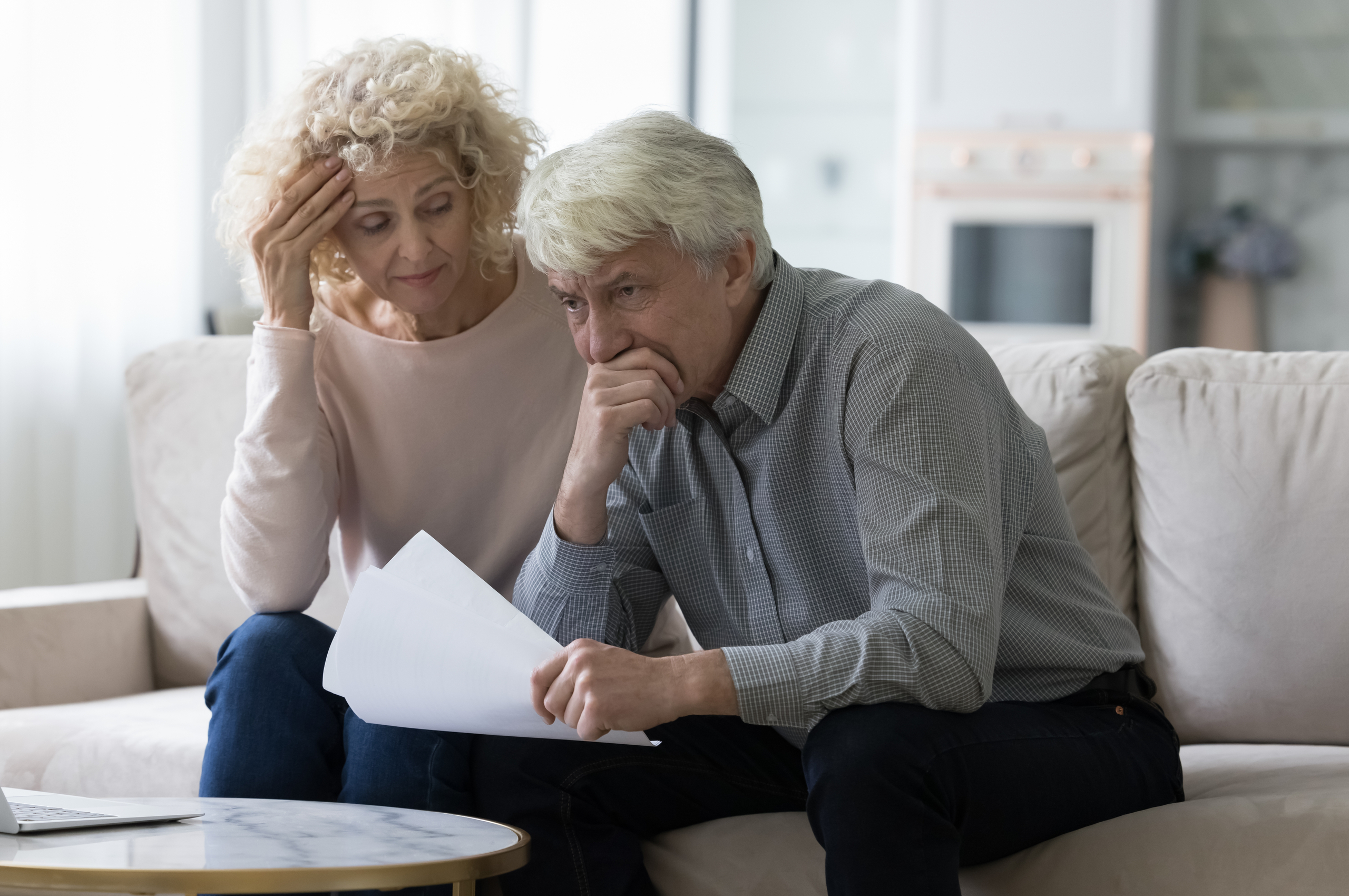 Concerned mature couple looking at paperwork